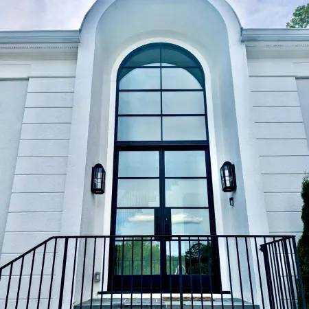 Modern front entry with tall glass and black iron front entry