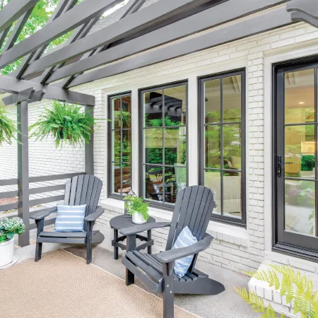 Black fiberglass back door on white brick house