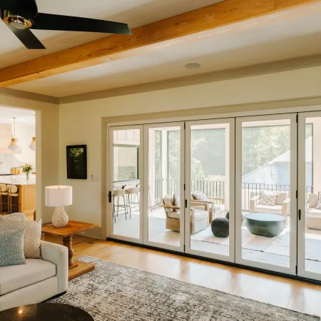 Living room with white fiberglass bifold door leading to balcony.
