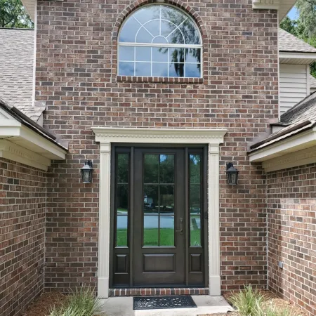 Brick house with black entry door and 2 sidelites by ProVia, a leading door manufacturer