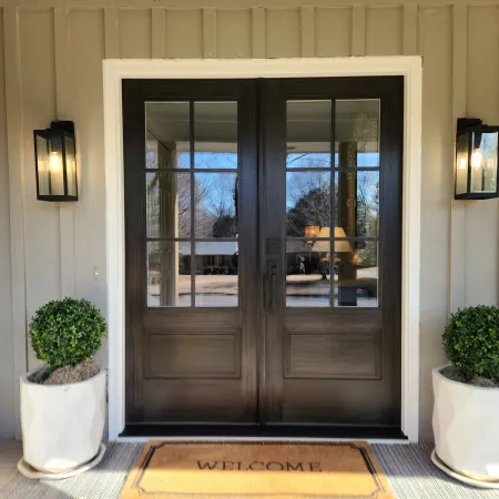 Front porch with double front doors stained to dark with glass