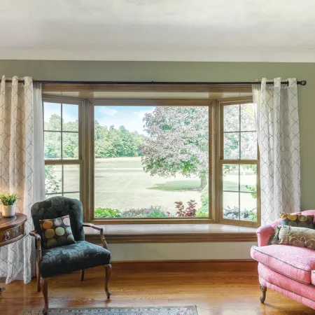 a living room with a large bay window for beautiful views of the front yard
