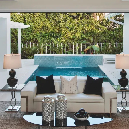 Living room connects to pool deck when Euro-Wall bi-fold patio door is open