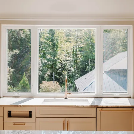 Kitchen with white casement windows above kitchen sink allowing easy to open access