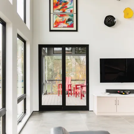 White room with modern black French doors leading onto balcony