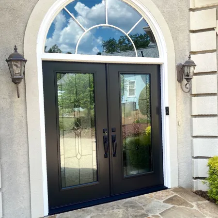 Black double entry doors from Provia with decorative glass on house