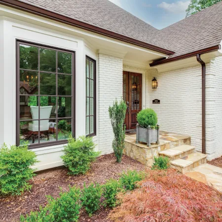 white brick house with brown windows