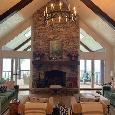 Large fireplace in living room with white hinged patio doors on wither side