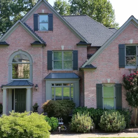 A brick house with board and batten shutters