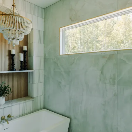 a bathtub and a shower in a bathroom with a long picture window 