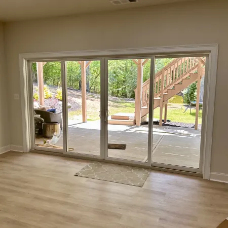 Looking into the backyard through a white sliding door. 