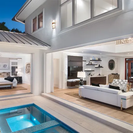 Euro-Wall folding patio door opens bedroom and living room to backyard pool area