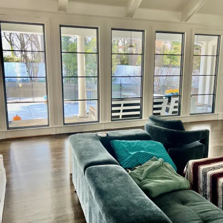 Inviting living room with tall modern picture windows with horizontal grids