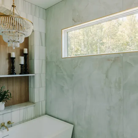 large transom window in a shower with a freestanding bath tub
