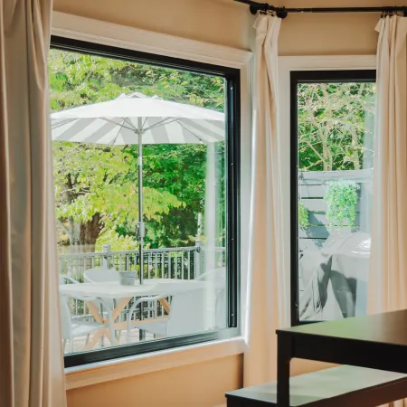 a room with a table and chairs large black picture windows from Infinity from Marvin