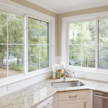 a kitchen with 2 large slider windows above the kitchen sink