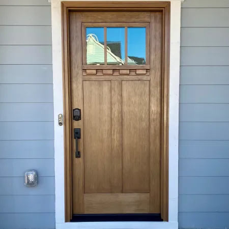 Craftsman front door with glass from ProVia door manufacturer on blue house