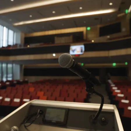 a microphone on a podium in a room with red seats