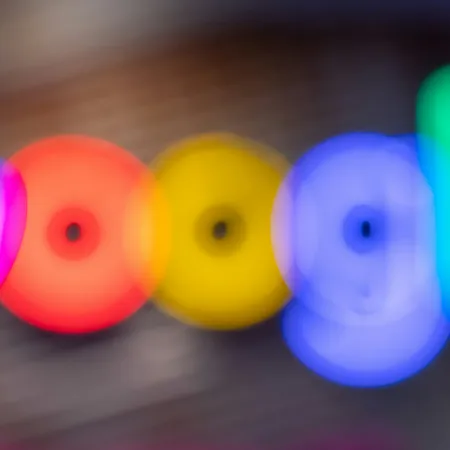Blurred colorful lights forming the Google logo with blue, red, yellow, and green hues on a dark background.