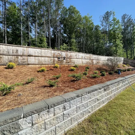 a garden with a stone wall