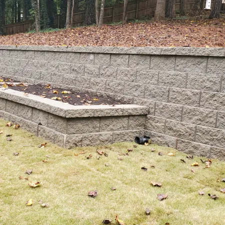 a stone wall with a bench and a stone wall