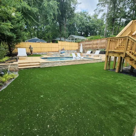 a backyard with a pool and a fence