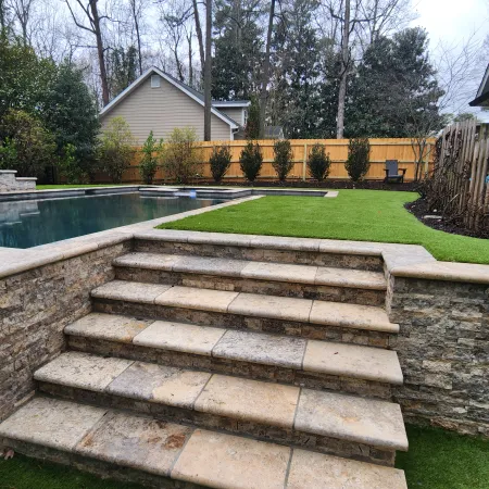 a stone staircase leading up to a swimming pool