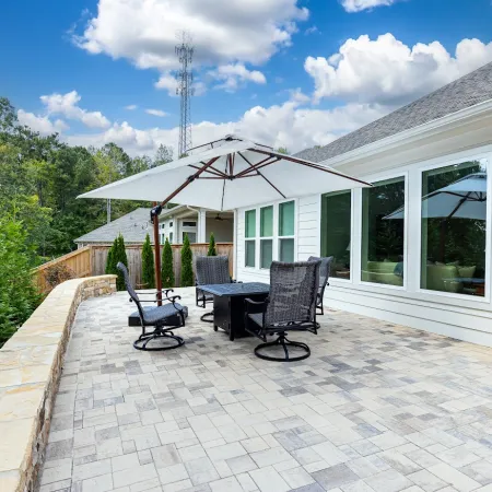 a patio with chairs and a table