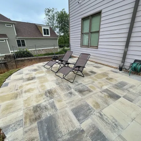 a patio with chairs and a table