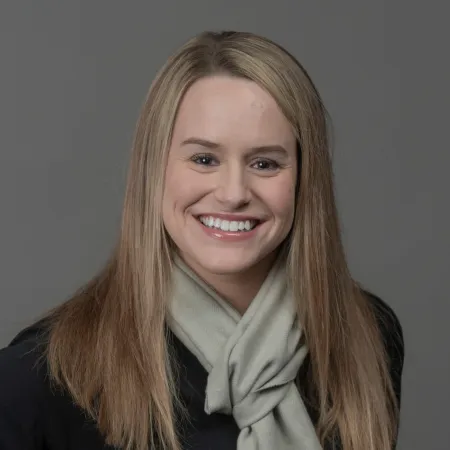 a person with long hair smiling