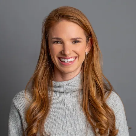 a person with long hair smiling