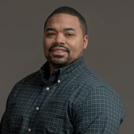 a man standing in front of a black background