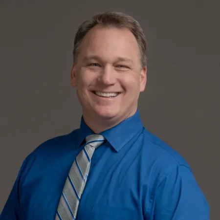 a man in a blue shirt and tie