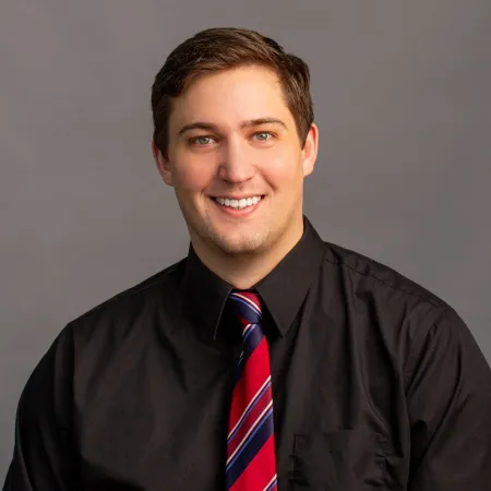 a man in a suit smiling