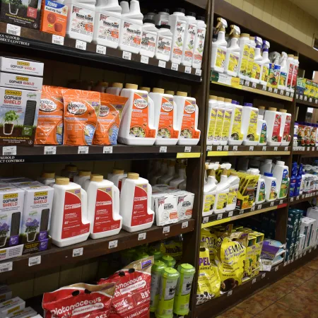Store shelves stocked with various gardening and pest control products in colorful packaging.