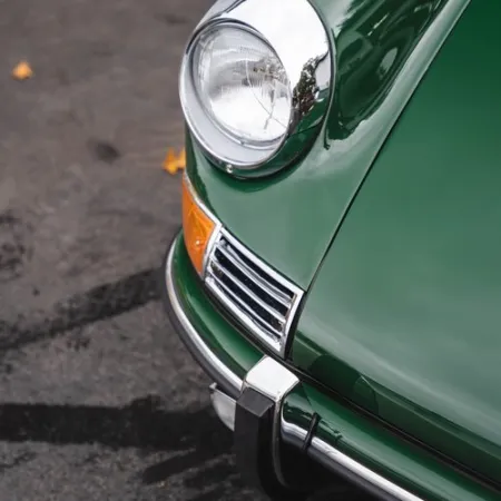 a green car with its headlights on