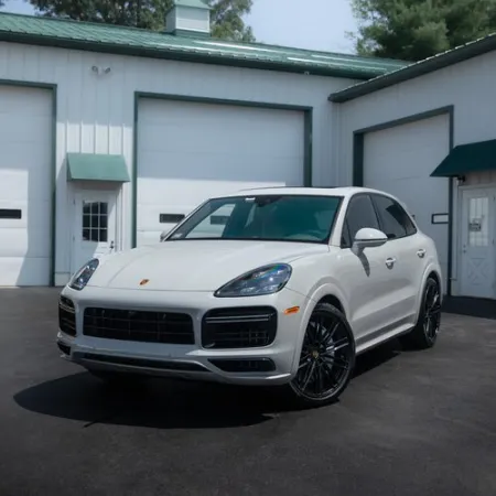 a white car parked in front of a garage