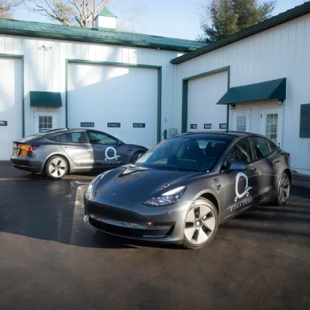 a couple of cars parked in front of a garage