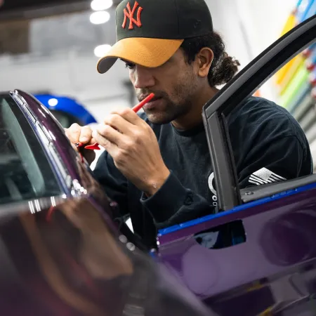 a man in a car smoking a cigarette