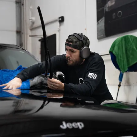 a man wearing headphones and sitting in a car