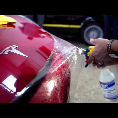 a person cutting a red car