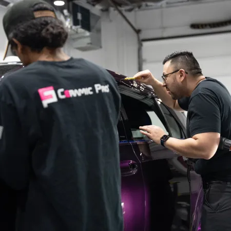 a couple of men looking at a car