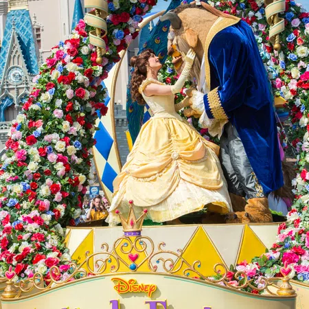 Beauty and the Beast characters on floral-decorated float at Disney Festival of Fantasy parade