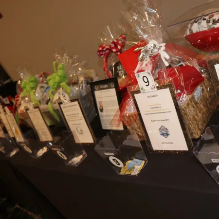 a table with a bunch of gift boxes and a red ribbon