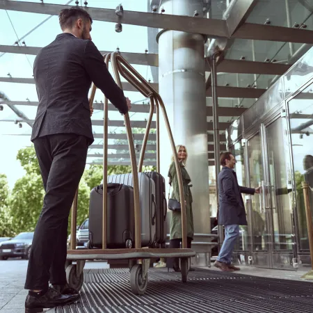 a man pushing luggage