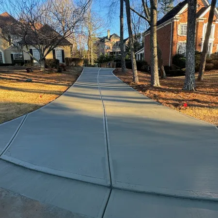 a sidewalk with trees and houses