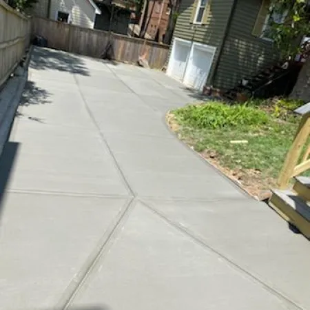 a sidewalk with houses and trees