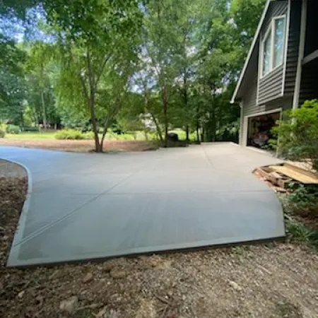 a driveway with trees and a house