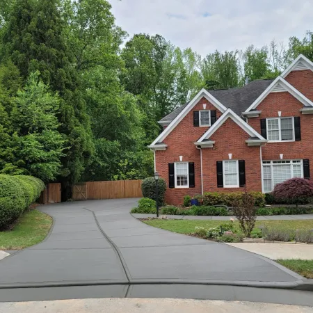 a house with a driveway and trees