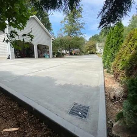 a driveway with a house in the background